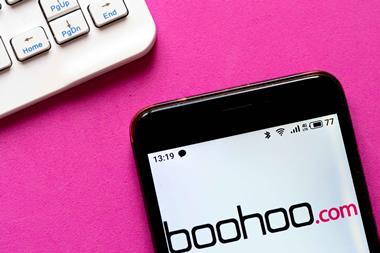 Boohoo logo on a pink background next to a computer keyboard