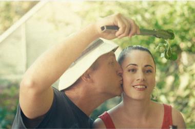 The ad shows a couple pretending to kiss under the mistletoe