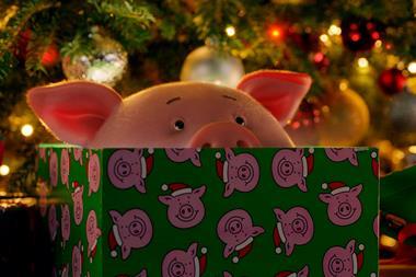 Percy Pig peering over a present in the M&S Christmas advert