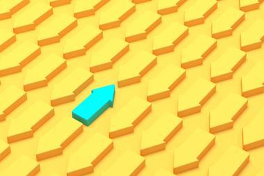 Against the grain: one green arrow going opposite direction to a sea of yellow arrows