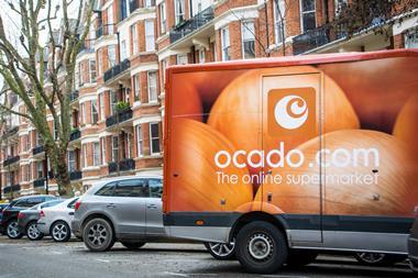 Ocado van outside a street of London red brick houses