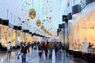 Customers walking through a shopping centre at Christmas