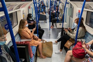 Passengers wearing face masks sat in London Underground train carriage