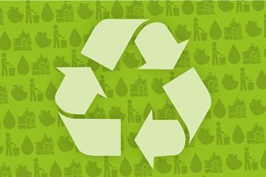 Green recycling symbol on a background of products