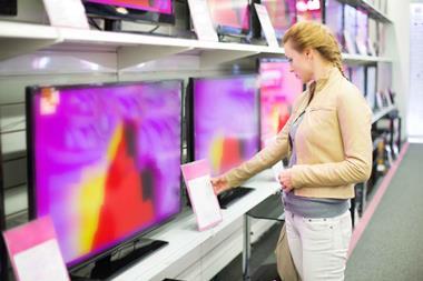 Woman-looking-at-TVs-in-electrical-shop