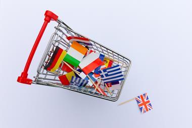 European flags in shopping trolley with UK flag on floor
