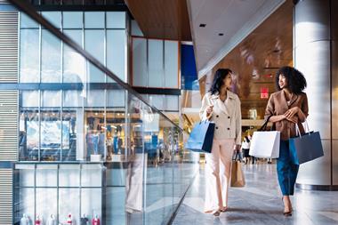 Two women carrying shopping bags