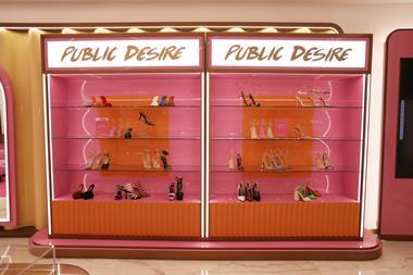 Interior of Public Desire shoe store in Riyadh, showing a rack of women's shoes and a sign saying 'Public Desire'