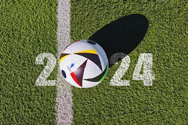 Football pitch with text saying 2024 and a football