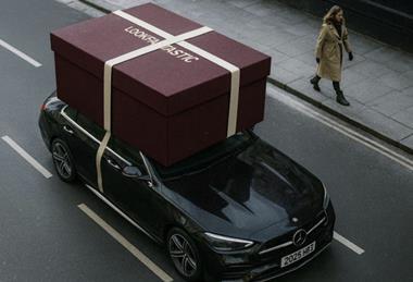 A giant Lookfantastic gift box on roof of an Uber Eats delivery car