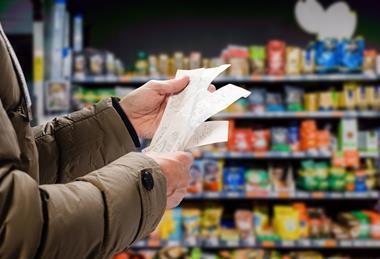 Customer reading grocery shopping receipt