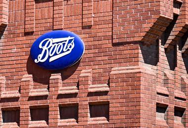 Boots sign on red brick wall