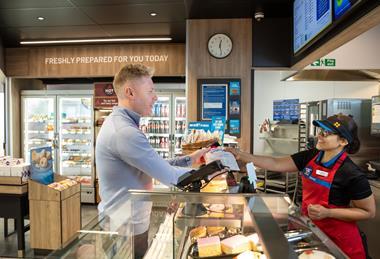 Customer being served at Greggs store