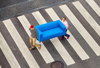 Customers carrying secondhand Ikea sofa