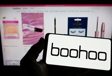 Boohoo logo on smarphone in front of the webpage