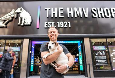 HMV owner Doug Putman poses with a dog outside HMV's Oxford Street store