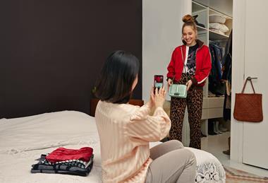 Woman taking photos of items to sell on Vinted