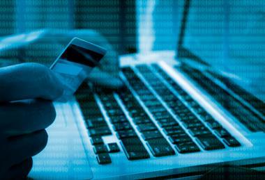 Computer code over a credit card and a laptop