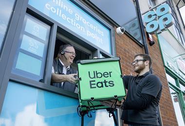 Uber Eats rider holding delivery bag