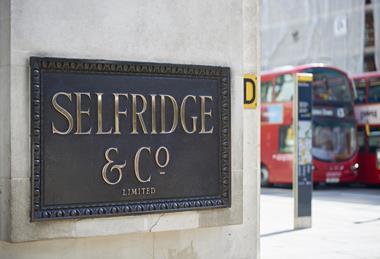 Brass Selfridges sign on London store wall