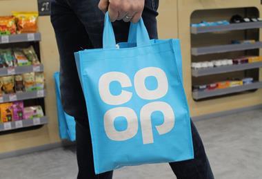Customer carrying Co-op tote bag