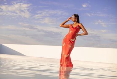 Woman wearing patterned dress from Debenhams