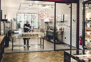 Butcher cutting ribs in Farmison & Co