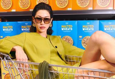 Model posing in front of cereal aisle