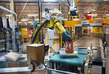 Robotic arm sorting packages at Amazon Innovation Lab