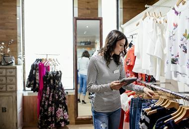 Worker checking stock in fashion store