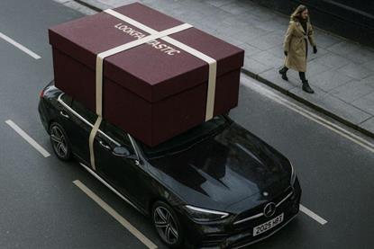 A giant Lookfantastic gift box on roof of an Uber Eats delivery car