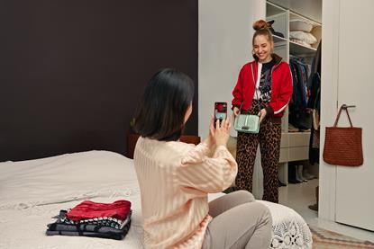 Woman taking photos of items to sell on Vinted