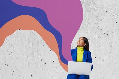 Woman working on laptop as abstract colours emerge from it