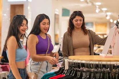 Friends choosing clothes to buy