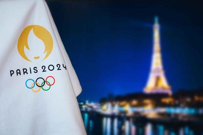 Paris-branded Olympics flag in front of Eiffel tower