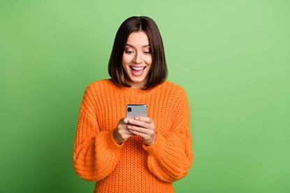 Woman smiling at mobile phone