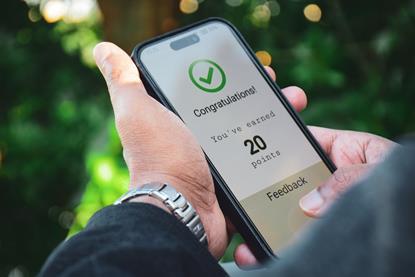 Phone displaying congratulation on earning loyalty points message