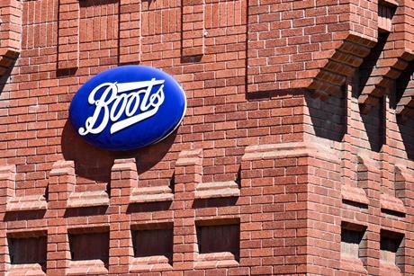 Boots sign on red brick wall