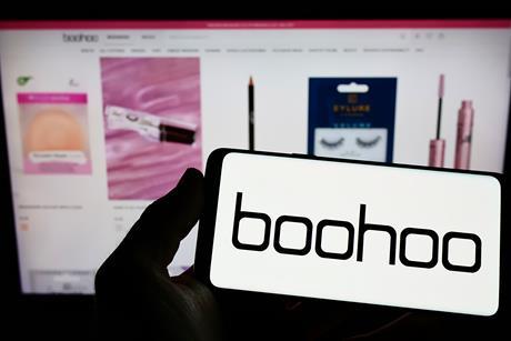 Boohoo logo on smarphone in front of the webpage