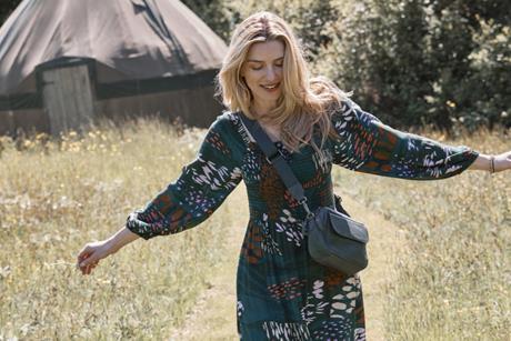 Model wearing Fat Face dress outdoors with a yurt in the background