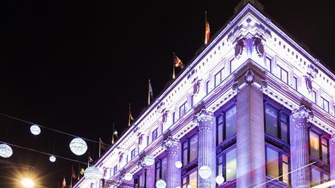 Selfridges department store lit up by night