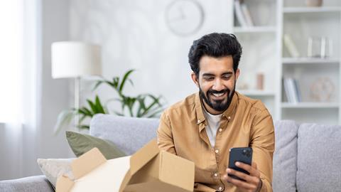 Man opening delivery box at home