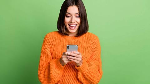 Woman smiling at mobile phone