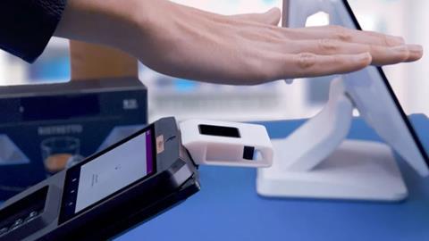 Hand making payment via Ingenico palm payment technology