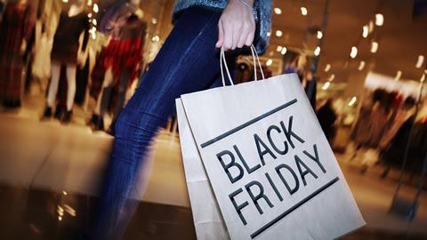 Lady holding a black Friday shopping bag