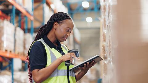 Warehouse worker using scanner and tablet