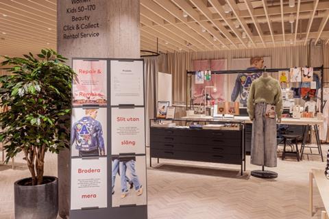 Interior of H&M store showing clothing as part of a sustainability display