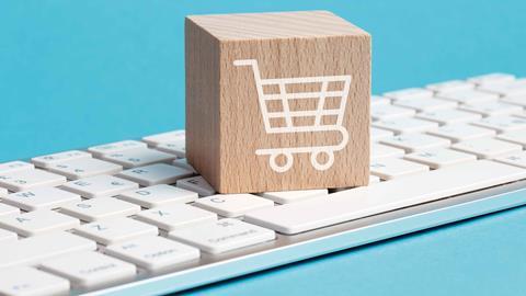 Wooden box illustrated with a shopping trolley sat on keyboard