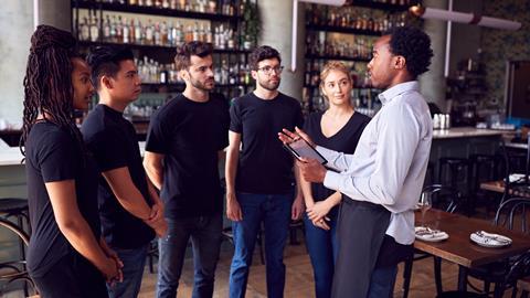Apprentices in a bar getting a lecture from the manager