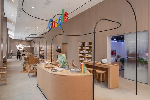 A worker in the Google store stands behind a counter